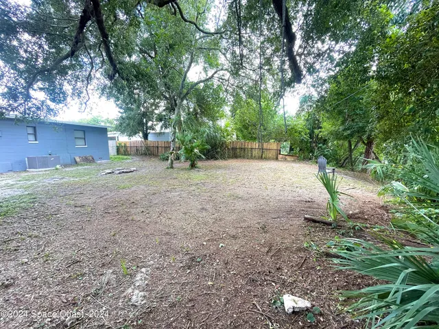 a backyard of a house with lots of green space
