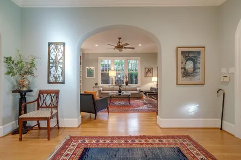 a living room with furniture a rug and a window