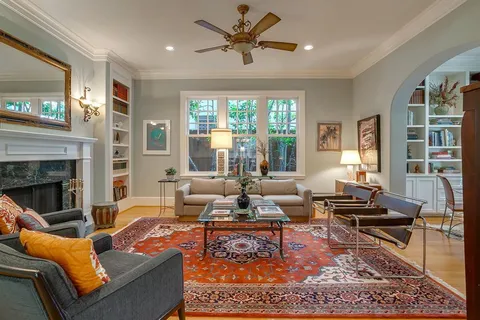 a dining room with furniture and a floor to ceiling window