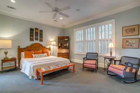 a bathroom with a granite countertop sink a mirror a bathtub and shower