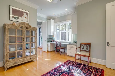 a bedroom with a bed chair and a window