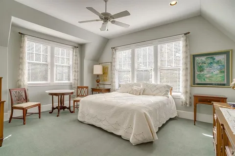 a bathroom with a granite countertop sink a potted plant and a window