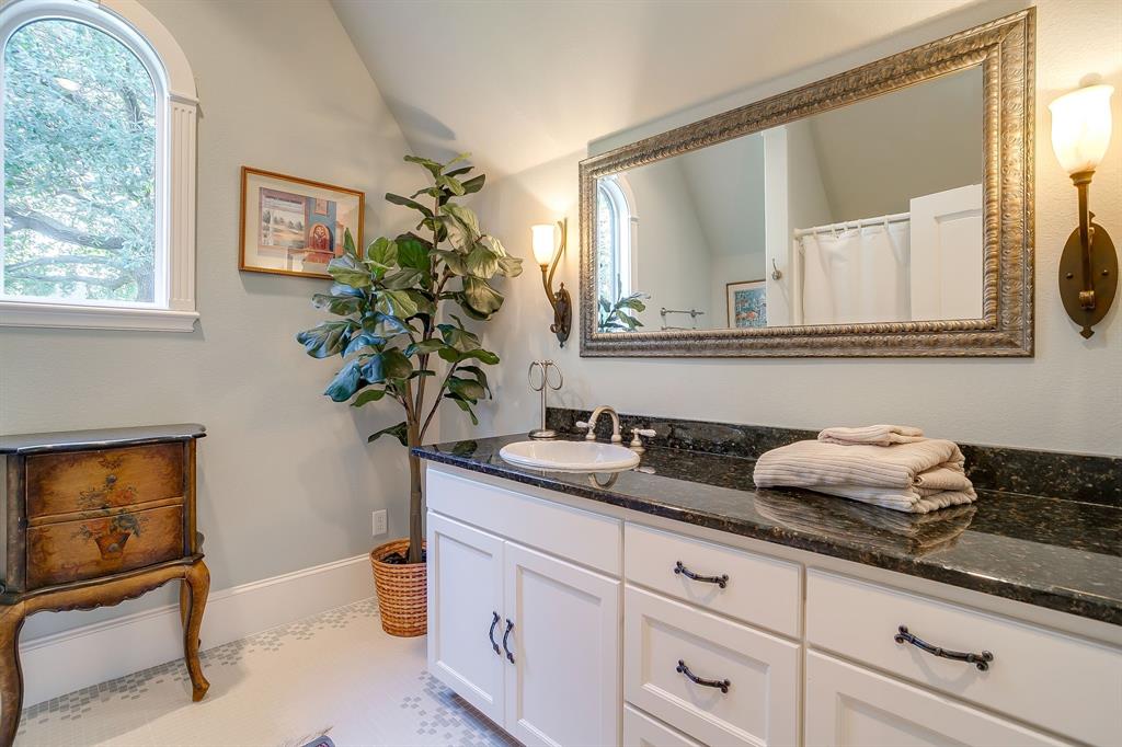 1620 Western Avenue Fort Worth, TX 76107 - Photo 37 of 40 a bathroom with a granite countertop sink a potted plant and a window