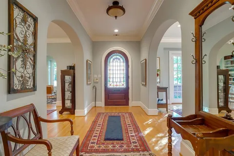 a view of a dining room with furniture and a chandelier