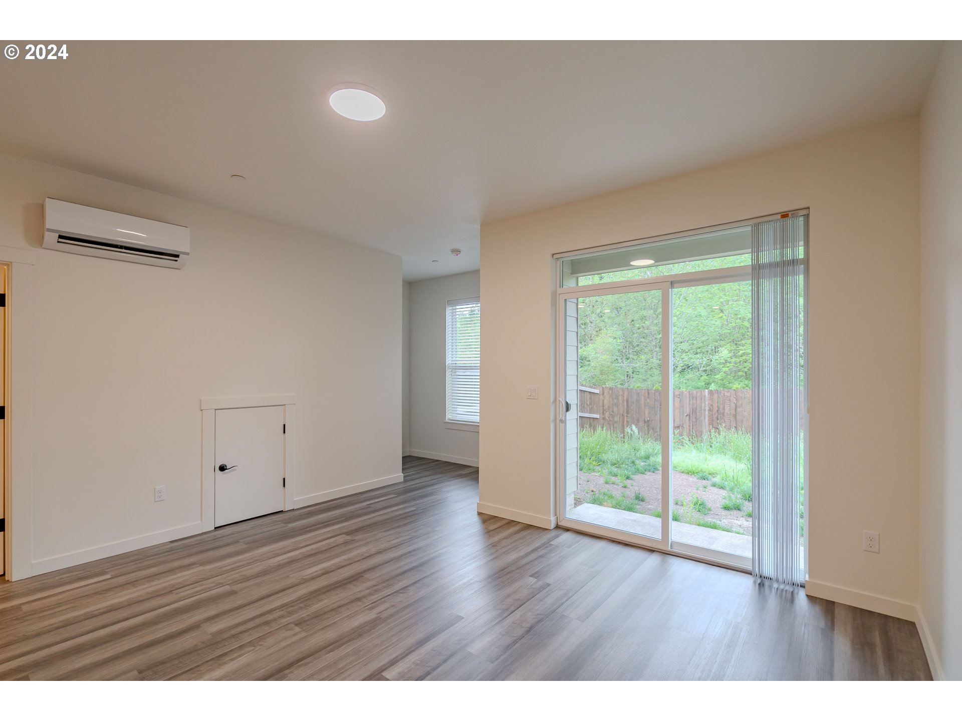 349 South 69th Place Ridgefield, WA 98642 - Photo 13 of 45 a view of an empty room with wooden floor and a window