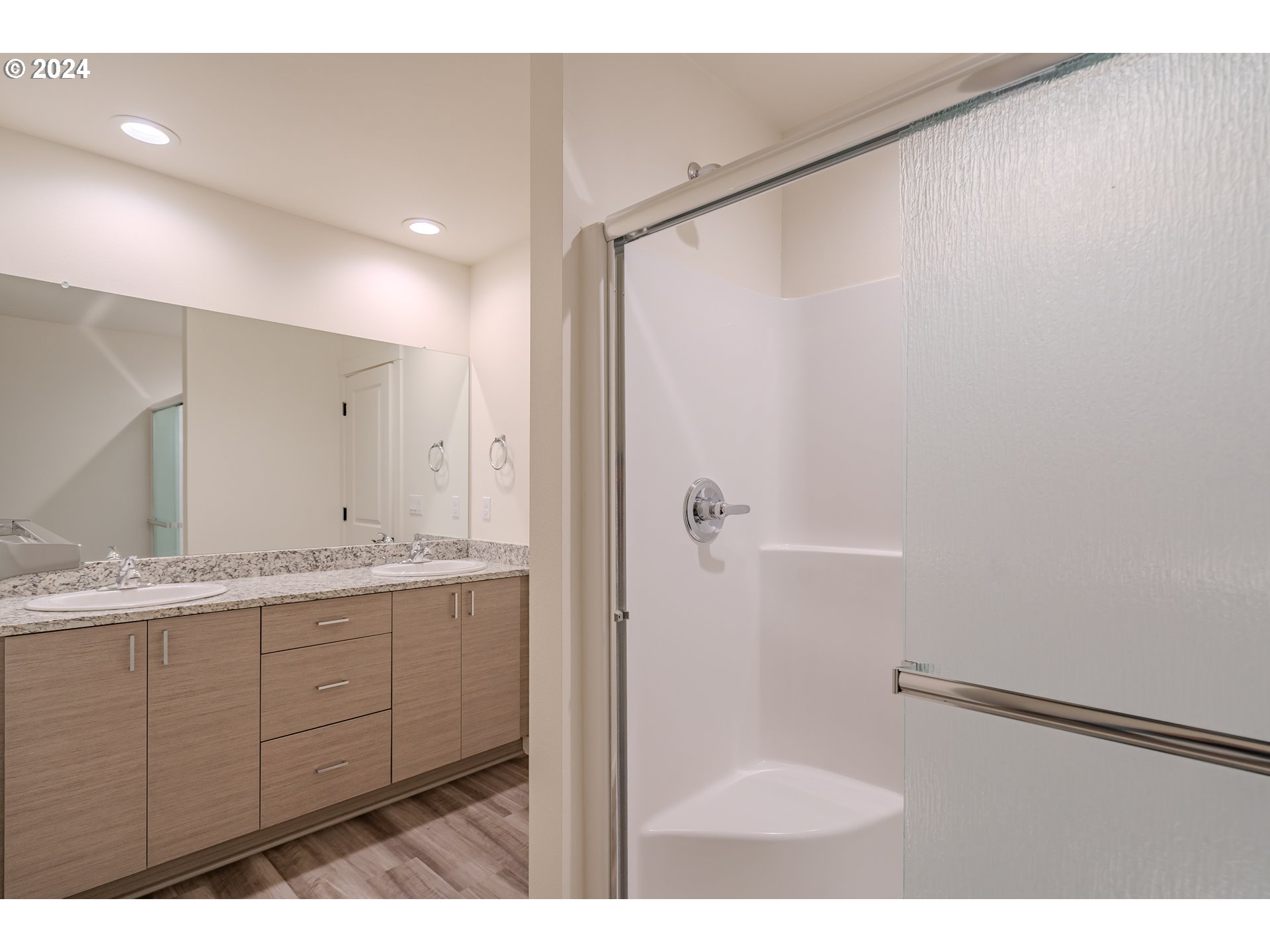 349 South 69th Place Ridgefield, WA 98642 - Photo 24 of 45 a bathroom with a granite countertop sink mirror and a shower