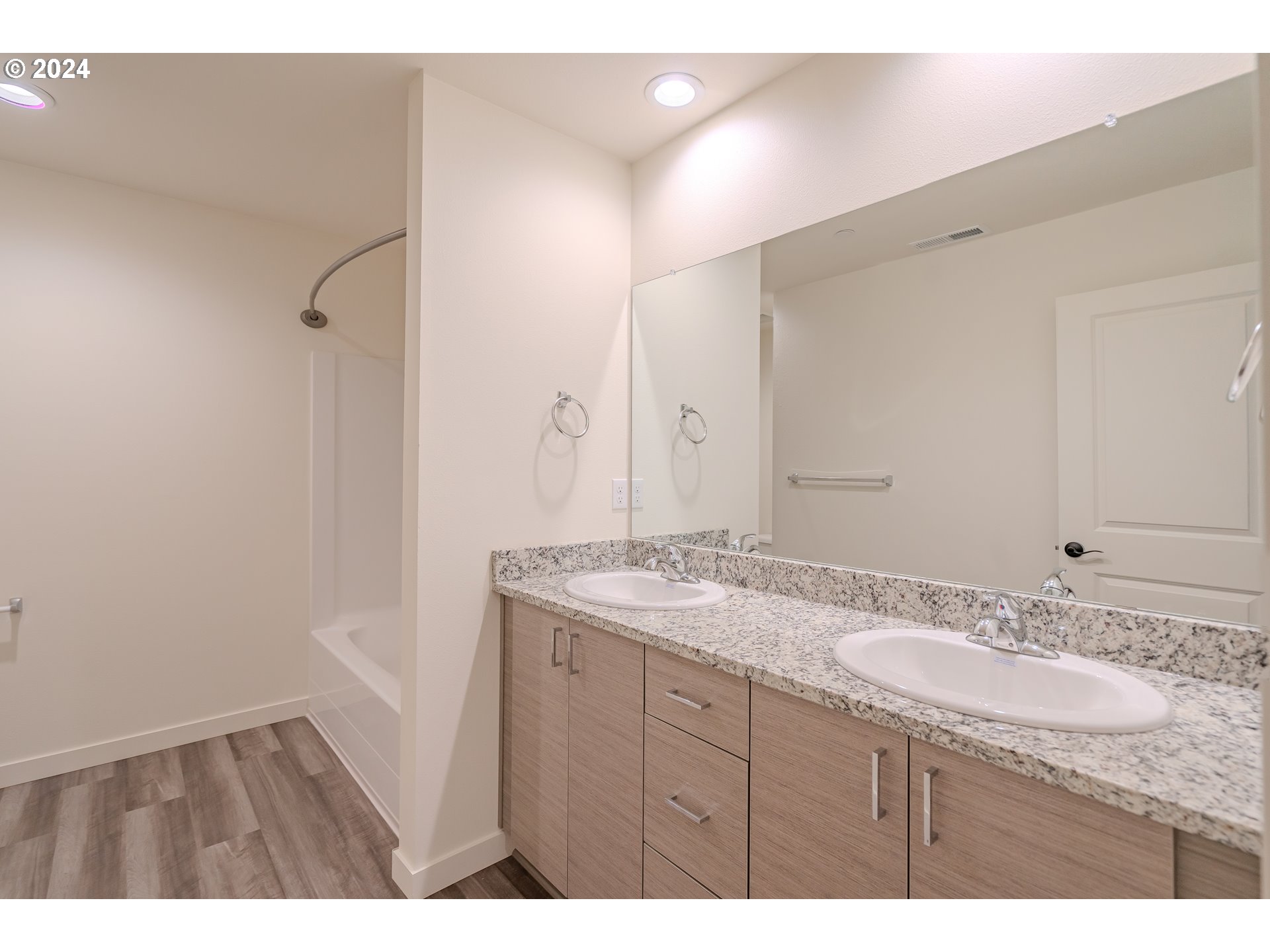 349 South 69th Place Ridgefield, WA 98642 - Photo 27 of 45 a bathroom with a granite countertop sink a mirror and a shower