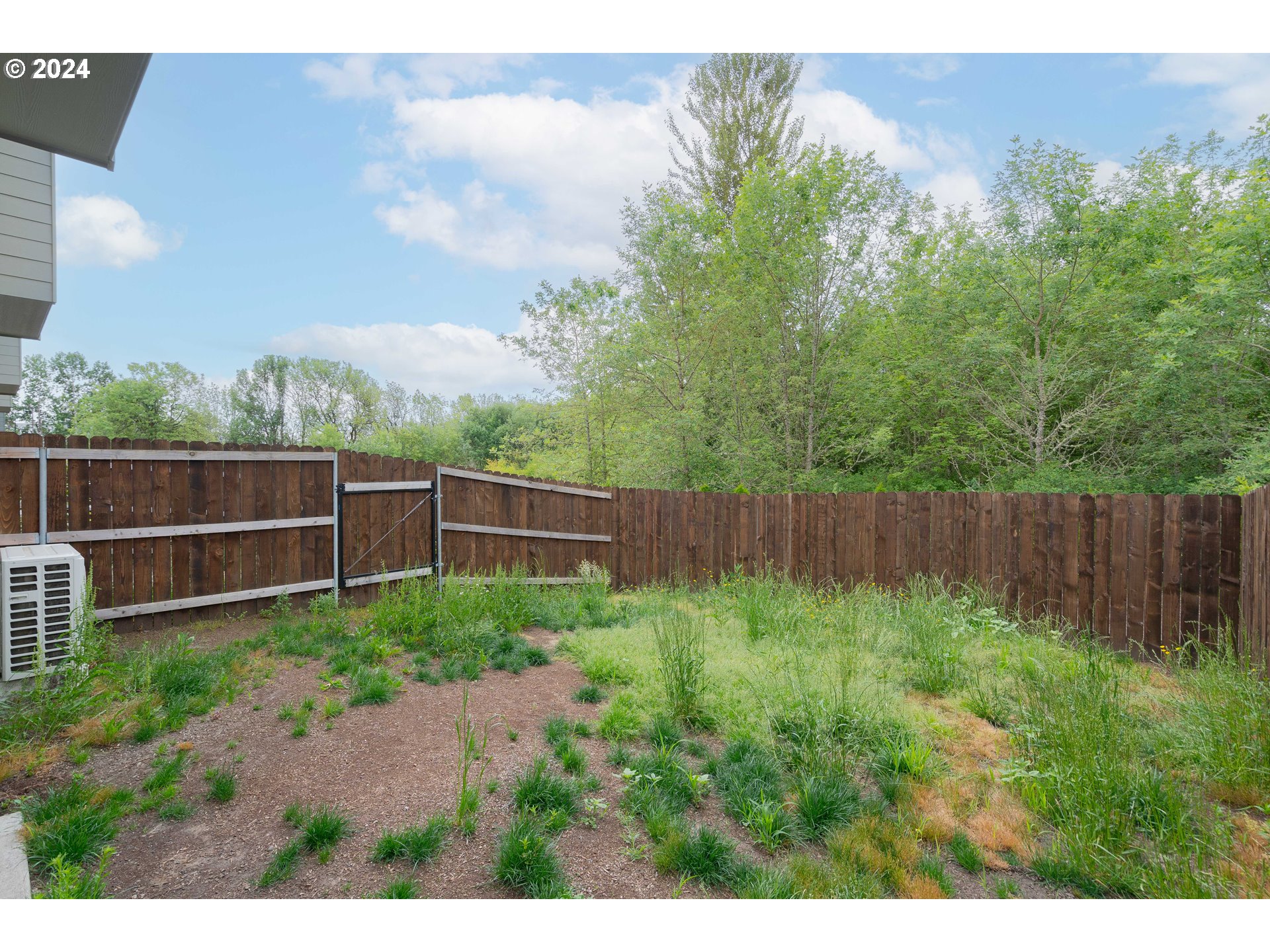 349 South 69th Place Ridgefield, WA 98642 - Photo 40 of 45 a view of a backyard with plants and a bench