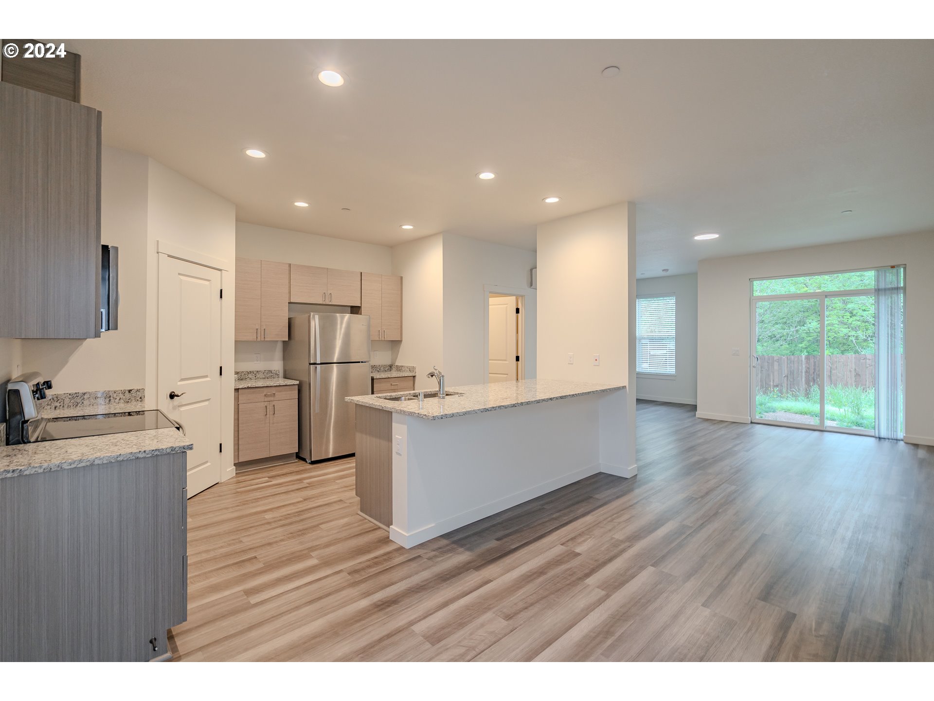 349 South 69th Place Ridgefield, WA 98642 - Photo 4 of 45 a open kitchen with kitchen island a sink dishwasher stove and wooden floors