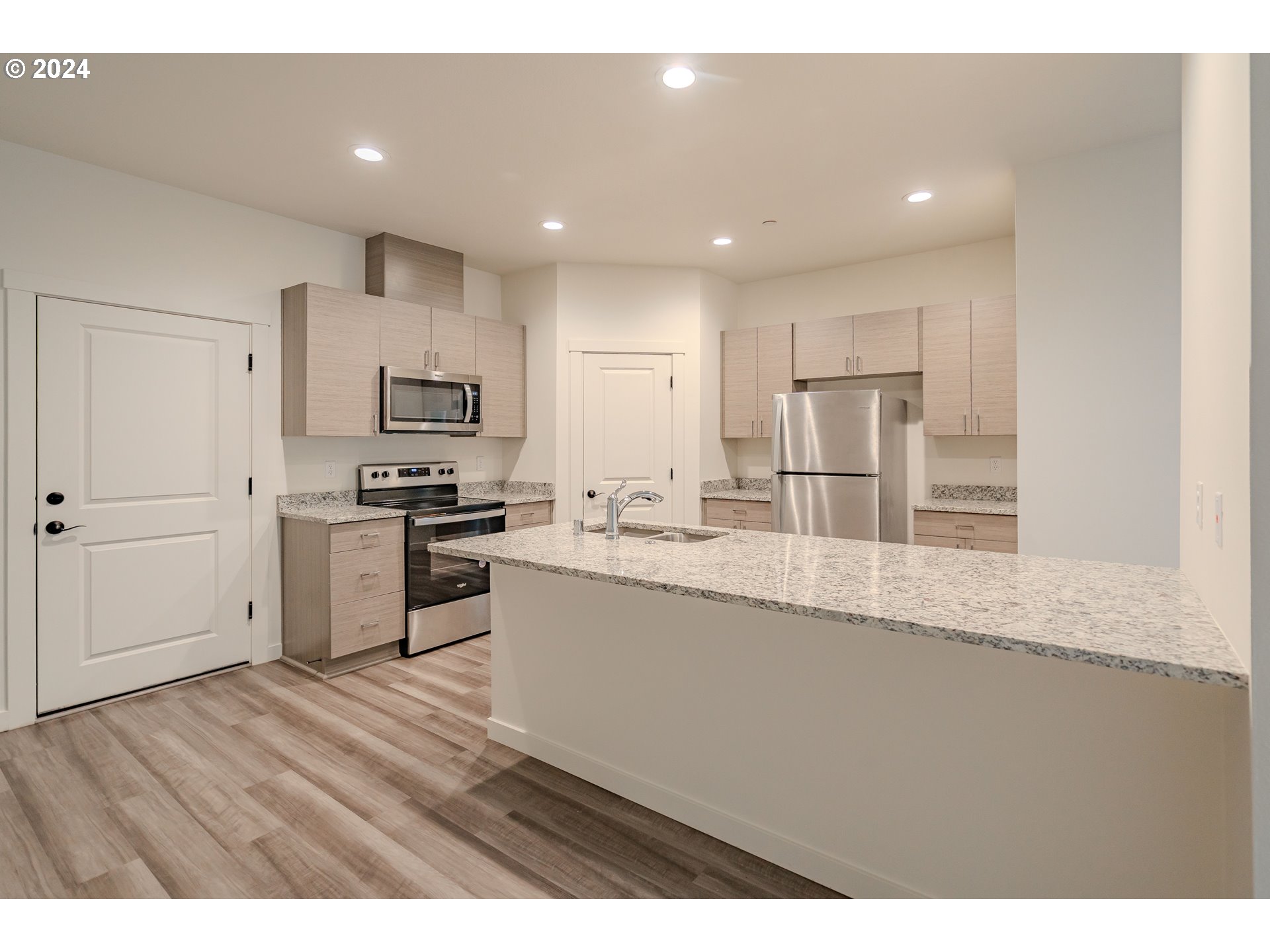 349 South 69th Place Ridgefield, WA 98642 - Photo 5 of 45 a kitchen with stainless steel appliances granite countertop a refrigerator a sink a stove and oven