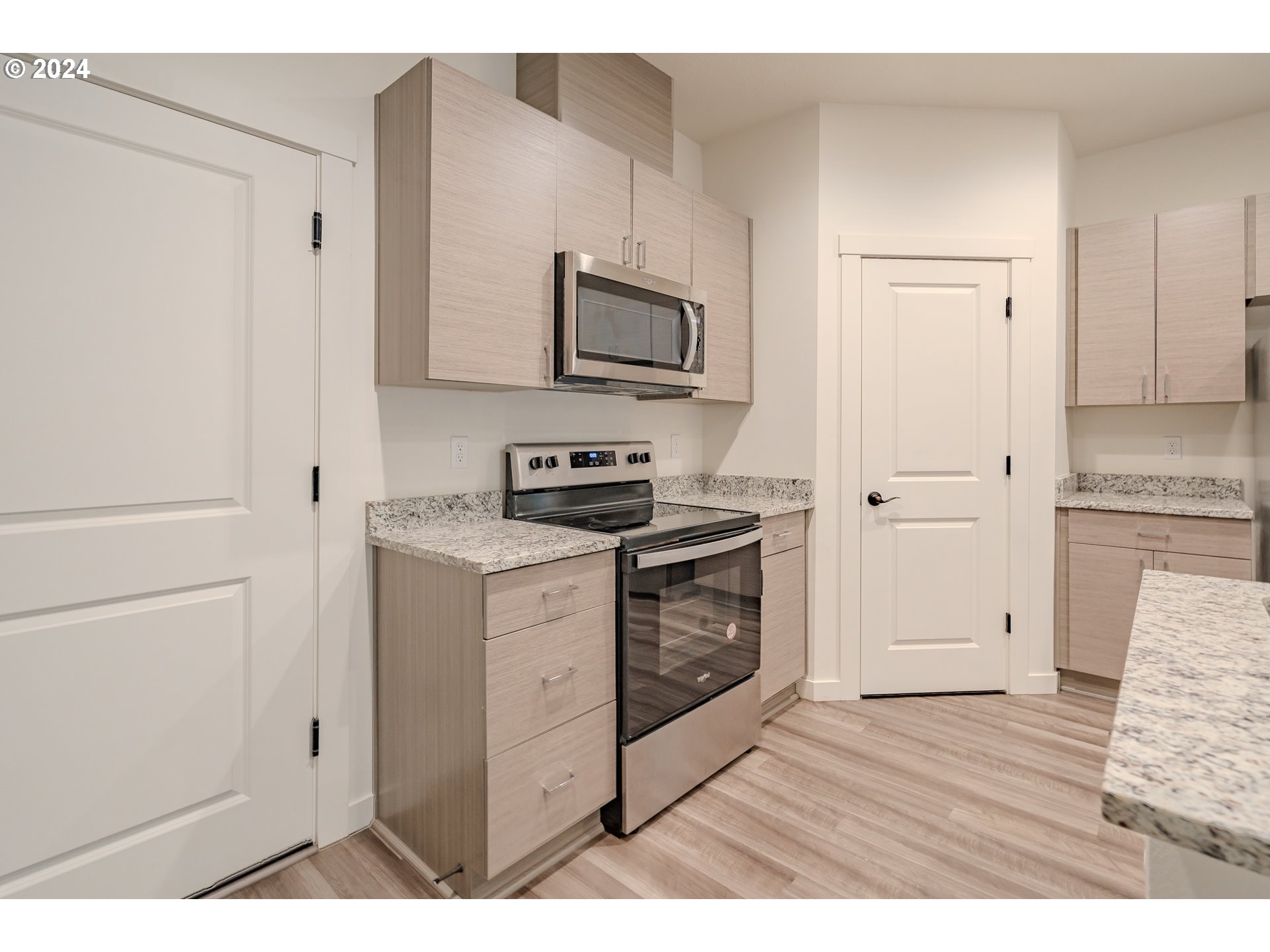 349 South 69th Place Ridgefield, WA 98642 - Photo 6 of 45 a kitchen with a refrigerator stove and white cabinets