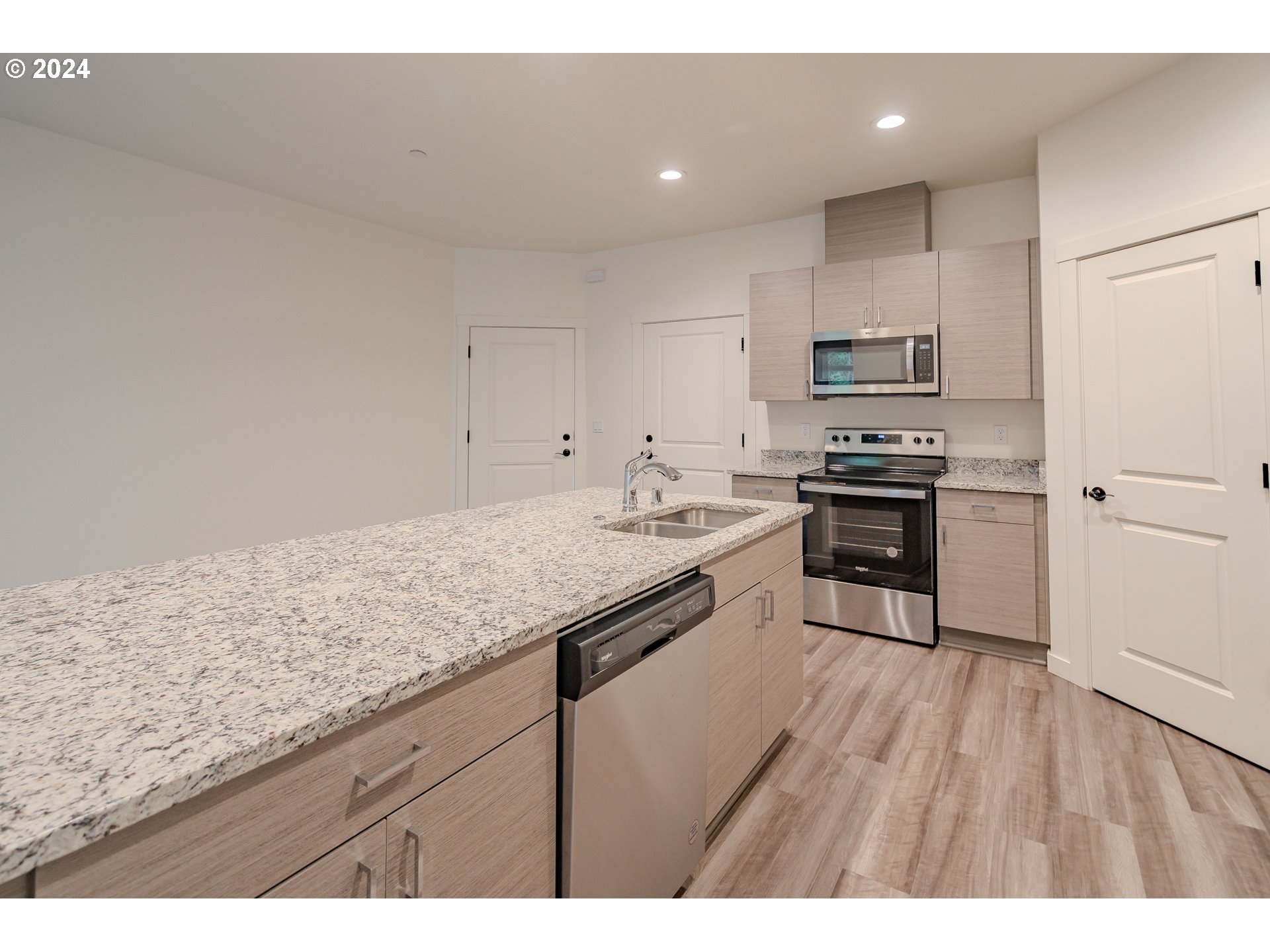 349 South 69th Place Ridgefield, WA 98642 - Photo 10 of 45 a kitchen with stainless steel appliances granite countertop a sink a stove a refrigerator and cabinets