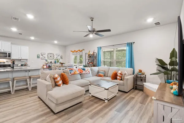 a living room with furniture fireplace and window