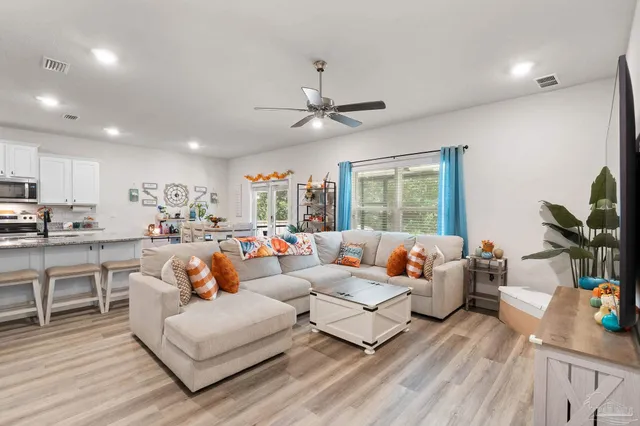 a living room with furniture fireplace and window