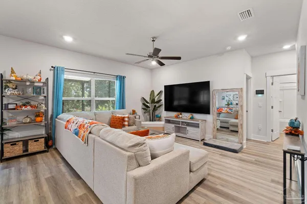 a living room with furniture and a flat screen tv