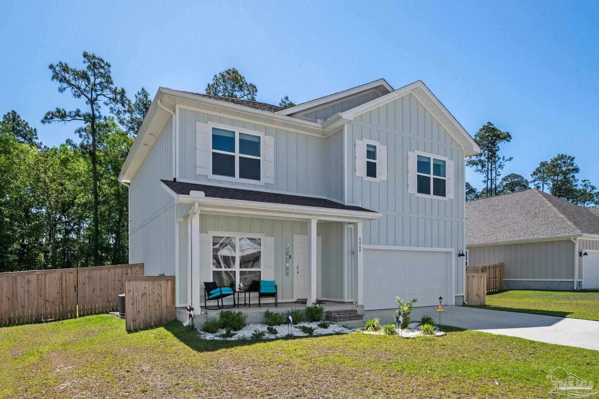 6060 Rutherford Loop Pensacola, FL 32526 - Photo 2 of 44 a front view of a house with garden