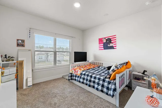 a bedroom with furniture and a window