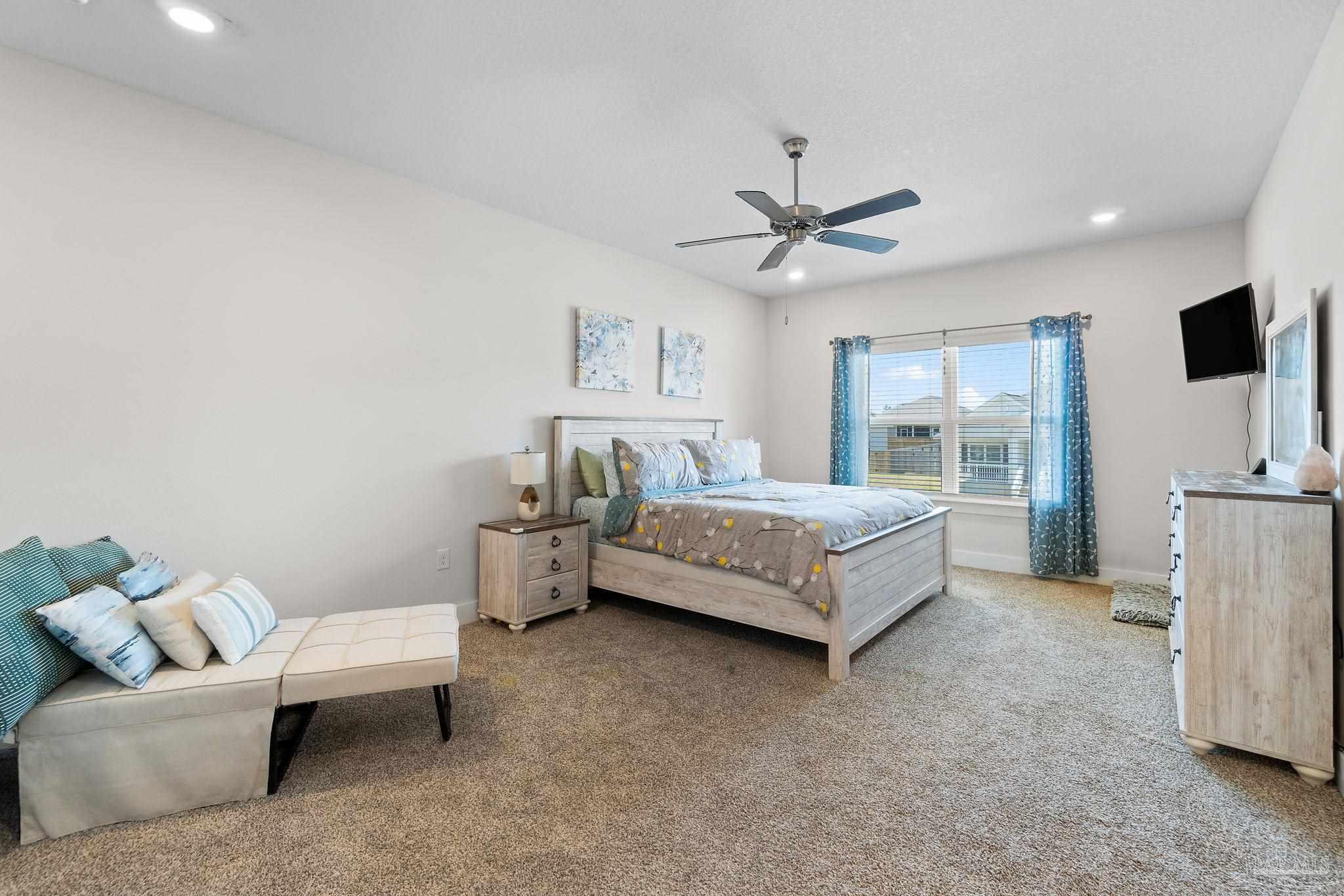 6060 Rutherford Loop Pensacola, FL 32526 - Photo 30 of 44 a bedroom with a bed couch and a large window