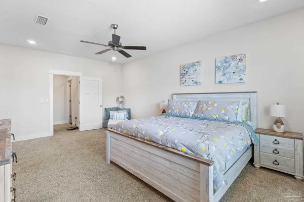 a bedroom with bed and painting on the wall