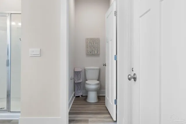 a bathroom with a toilet and a shower