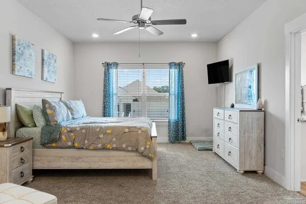a spacious bedroom with a bed and a couch