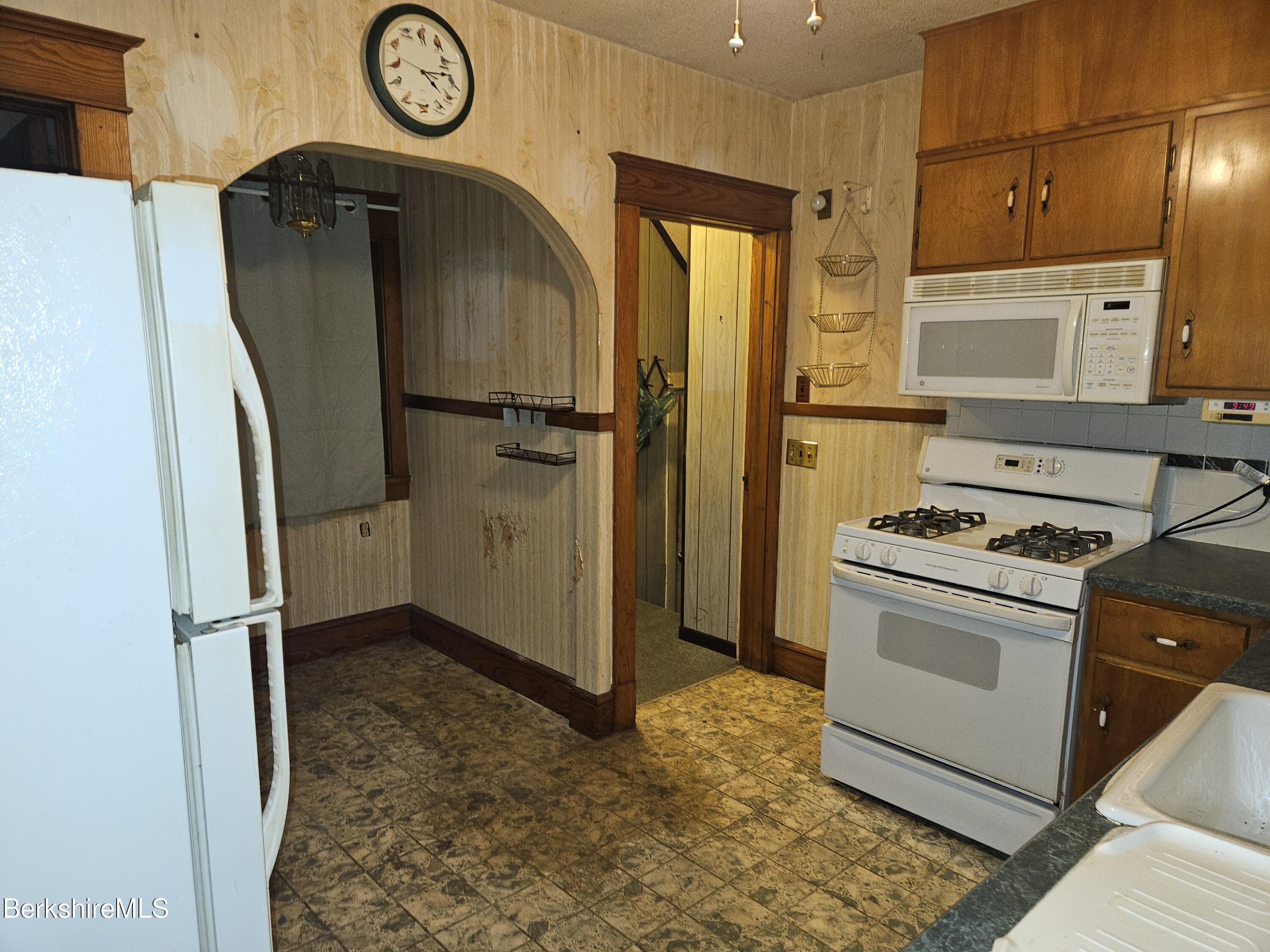 269 2nd Street Pittsfield, MA 01201 - Photo 15 of 39 a kitchen with a refrigerator and a stove top oven