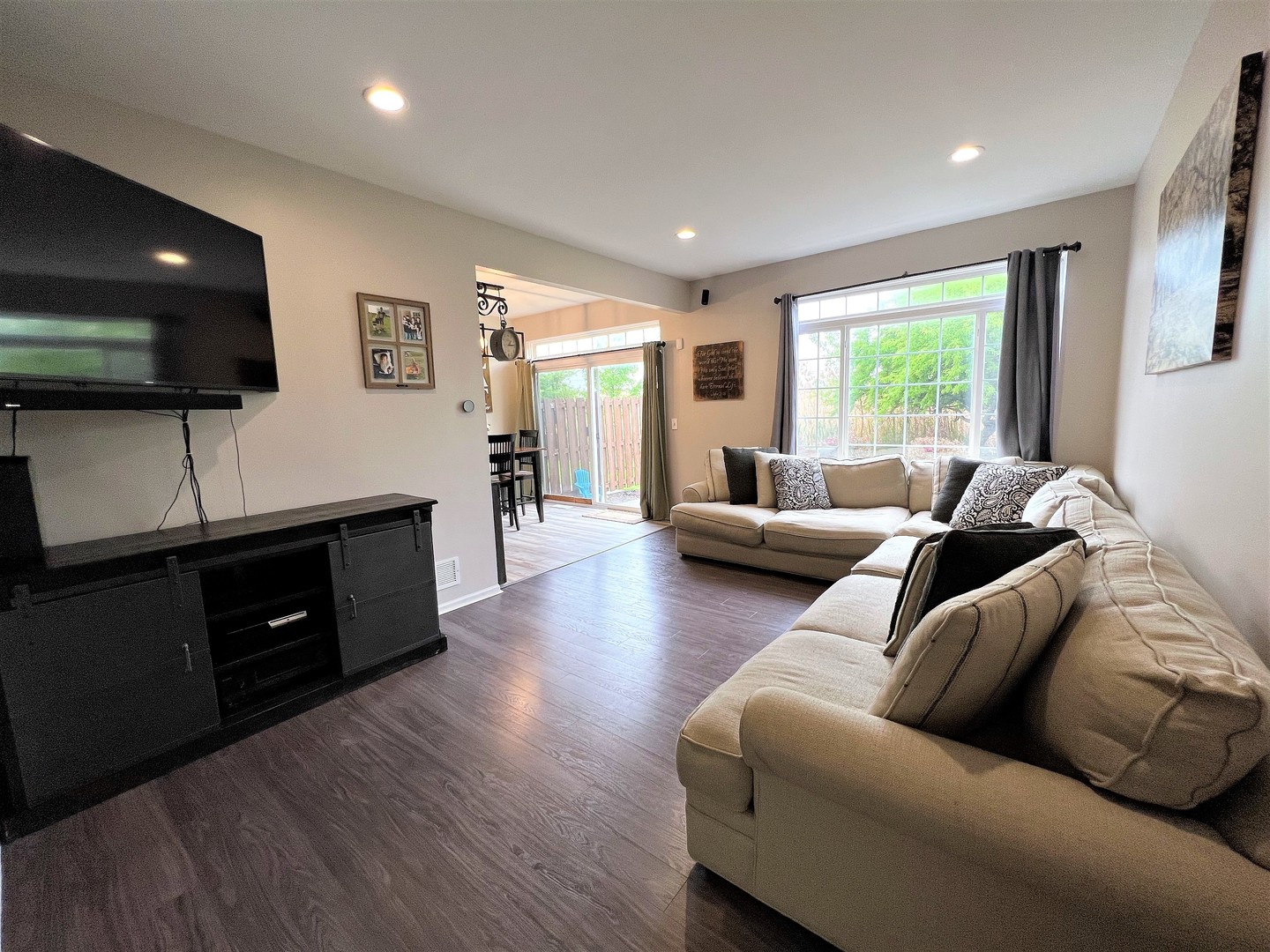8563 Scheer Drive, Unit 8563 Tinley Park, IL 60487 - Photo 3 of 30 a living room with furniture and a flat screen tv