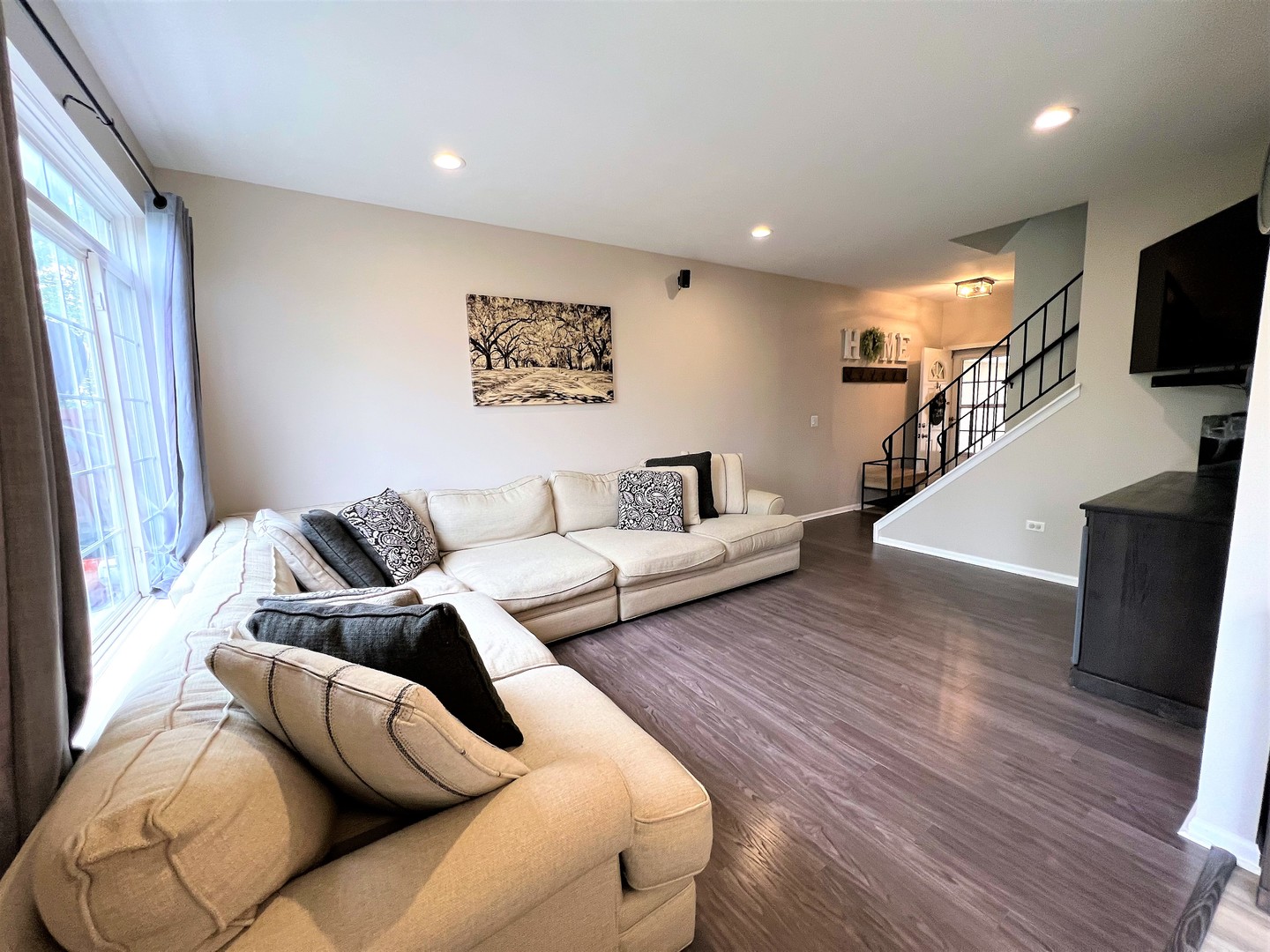 8563 Scheer Drive, Unit 8563 Tinley Park, IL 60487 - Photo 4 of 30 a living room with furniture and a flat screen tv
