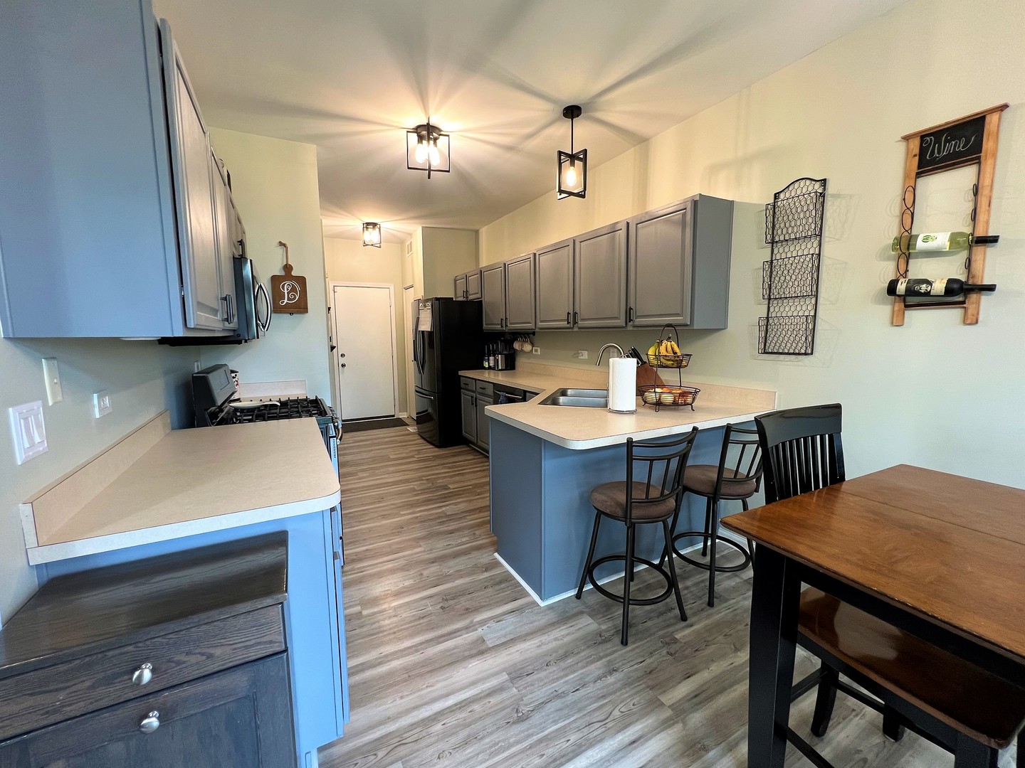 8563 Scheer Drive, Unit 8563 Tinley Park, IL 60487 - Photo 7 of 30 a kitchen with a table chairs refrigerator and cabinets