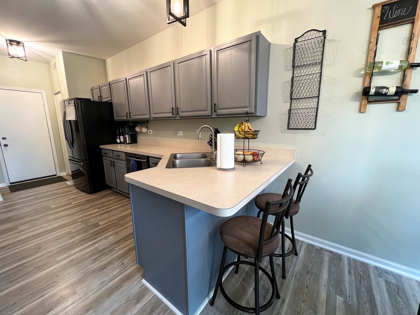 8563 Scheer Drive, Unit 8563 Tinley Park, IL 60487 - Photo 8 of 30 a kitchen with stainless steel appliances a sink cabinets and wooden floor