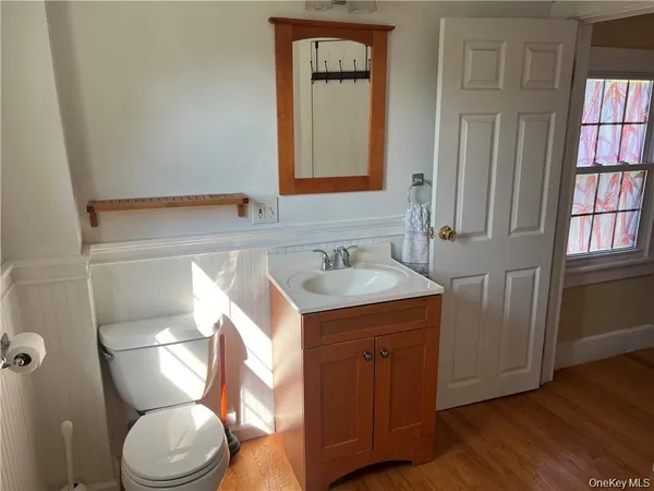 a bathroom with a toilet sink and mirror