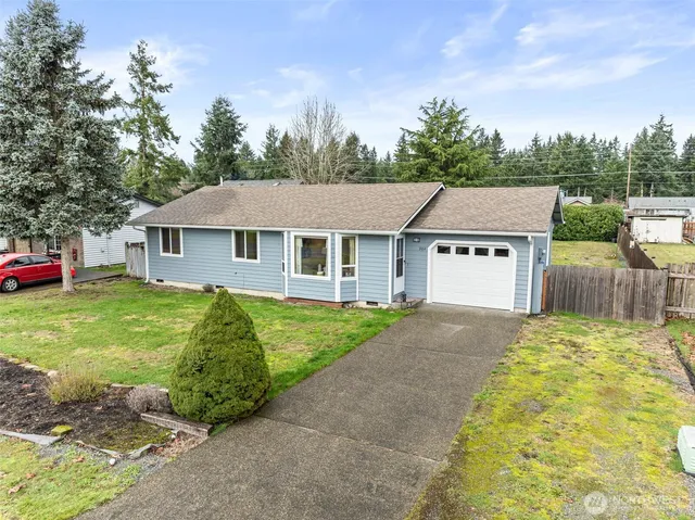 a aerial view of a house with a yard and trees