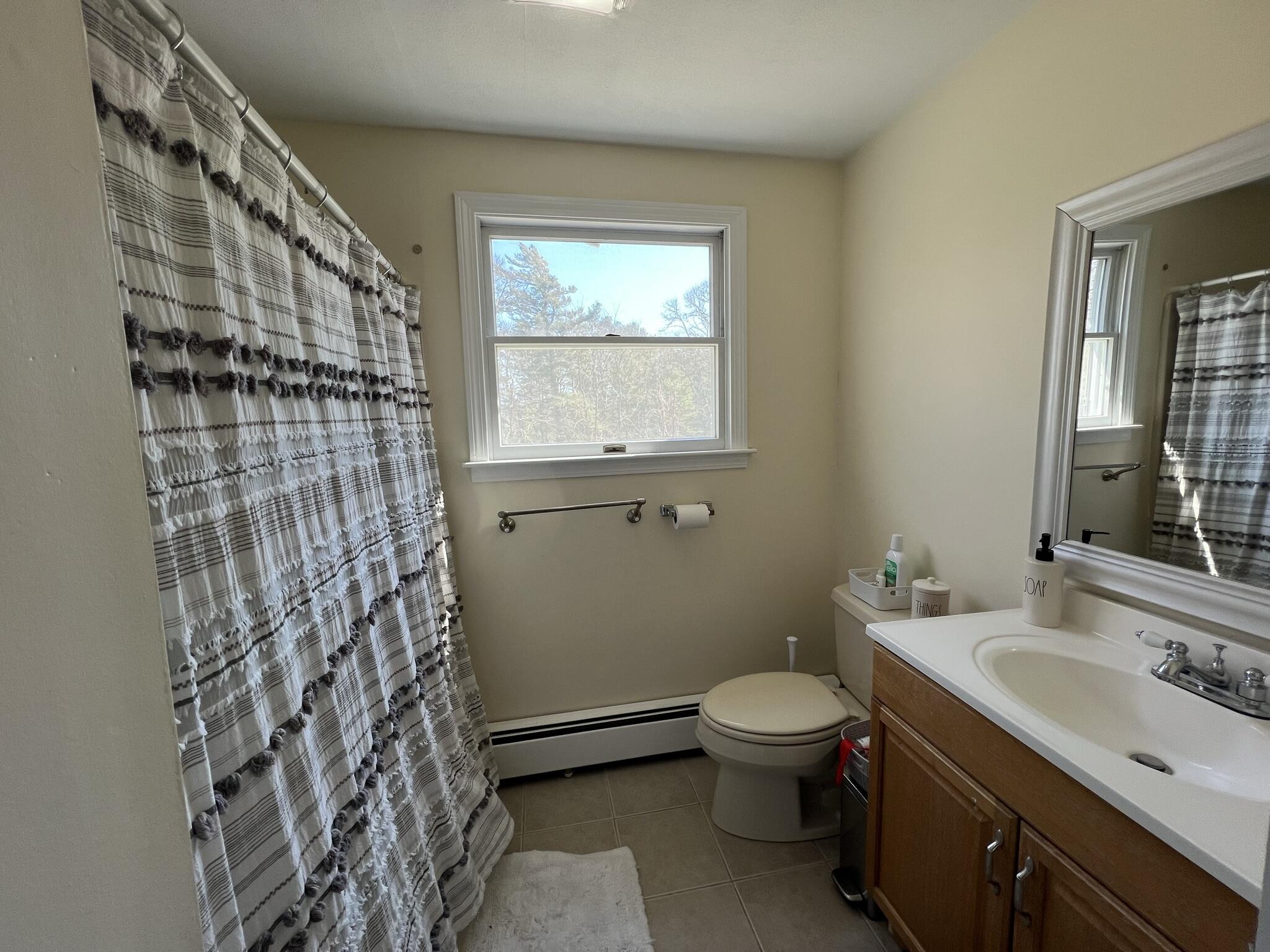 413 County Road Pocasset, MA 02559 - Photo 12 of 21 a bathroom with a granite countertop sink toilet and mirror