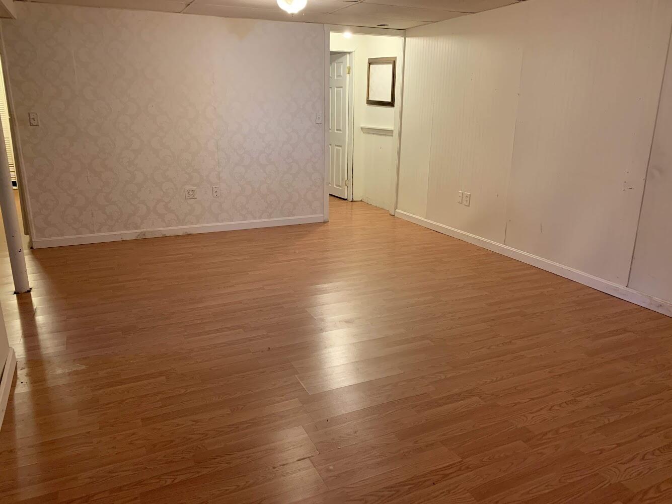 413 County Road Pocasset, MA 02559 - Photo 13 of 21 an empty room with wooden floor and windows