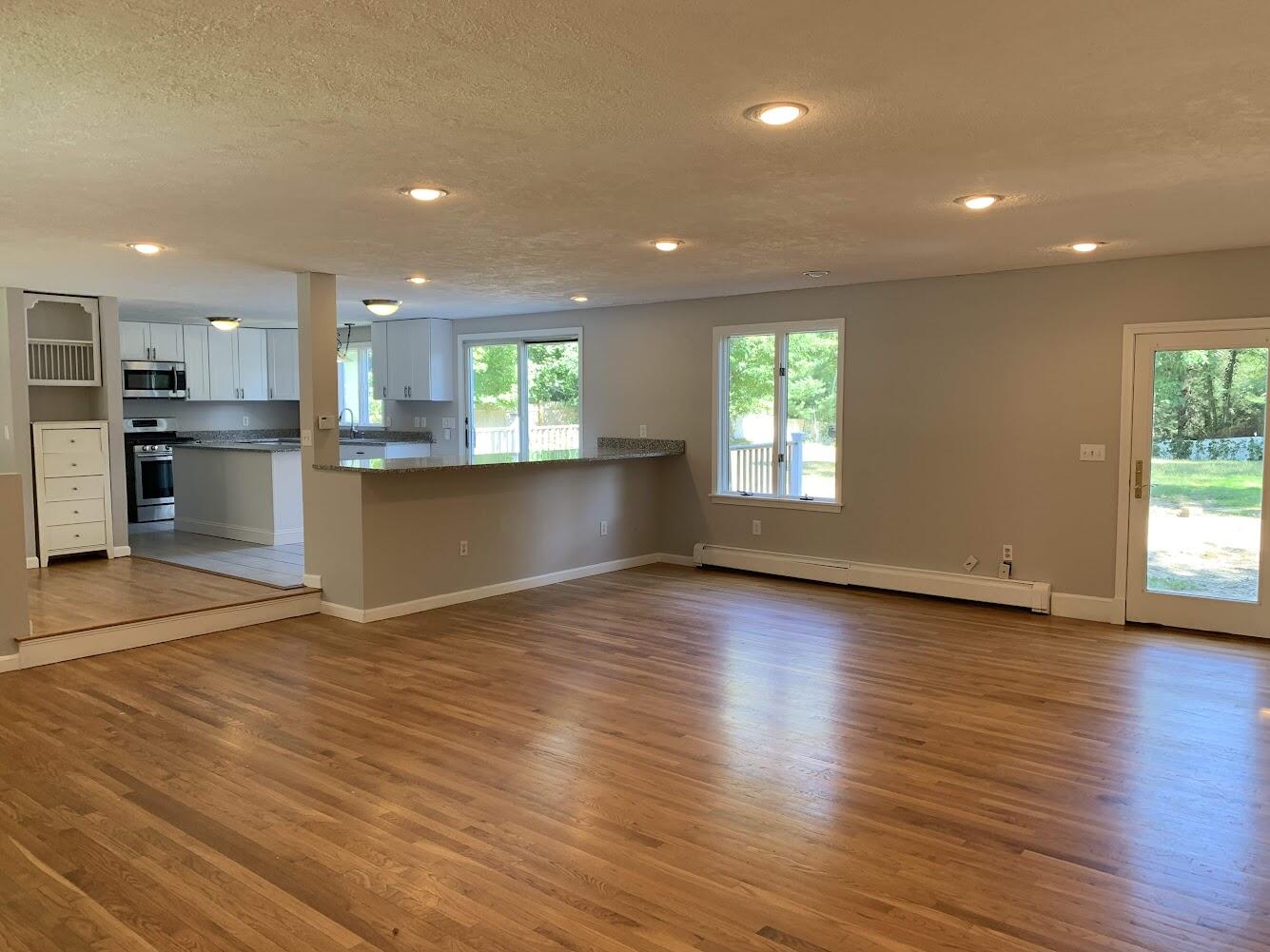 413 County Road Pocasset, MA 02559 - Photo 5 of 21 an empty room with wooden floor and windows