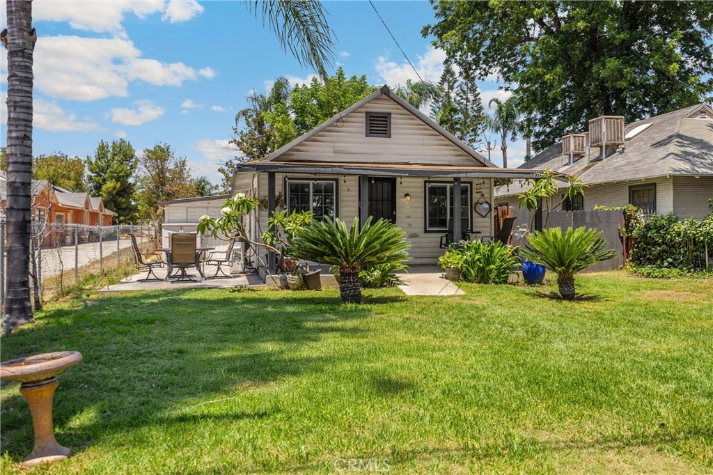1003 West Stevenson Street Colton, CA 92324 - Photo 1 of 27 a front view of a house with a garden