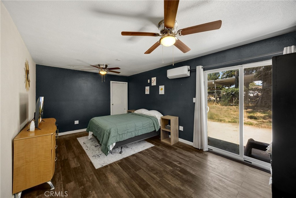1003 West Stevenson Street Colton, CA 92324 - Photo 14 of 27 a bedroom with a bed and wooden floor