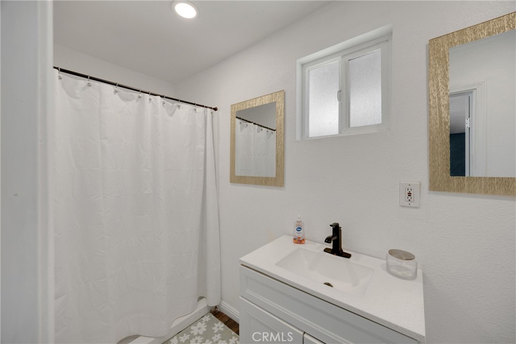 1003 West Stevenson Street Colton, CA 92324 - Photo 15 of 27 a bathroom with a sink a toilet and mirror