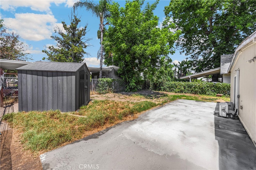 1003 West Stevenson Street Colton, CA 92324 - Photo 18 of 27 a view of backyard with small cabin and wooden fence