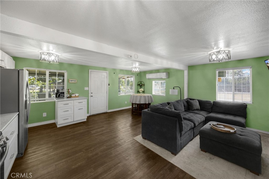 1003 West Stevenson Street Colton, CA 92324 - Photo 3 of 27 a living room with furniture and a open kitchen view