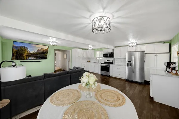 a view of a dining room with furniture and a chandelier
