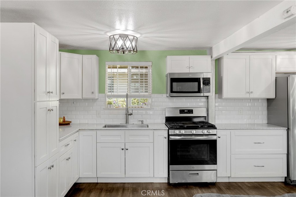 1003 West Stevenson Street Colton, CA 92324 - Photo 8 of 27 a kitchen with cabinets and appliances