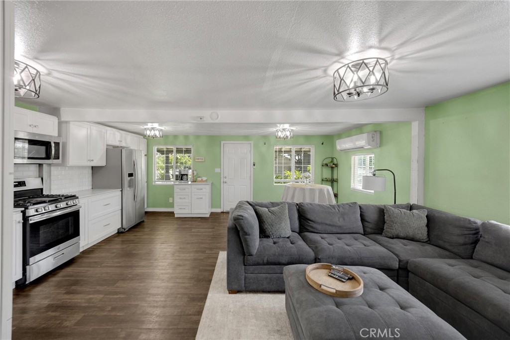 1003 West Stevenson Street Colton, CA 92324 - Photo 9 of 27 a living room with furniture a chandelier and kitchen view
