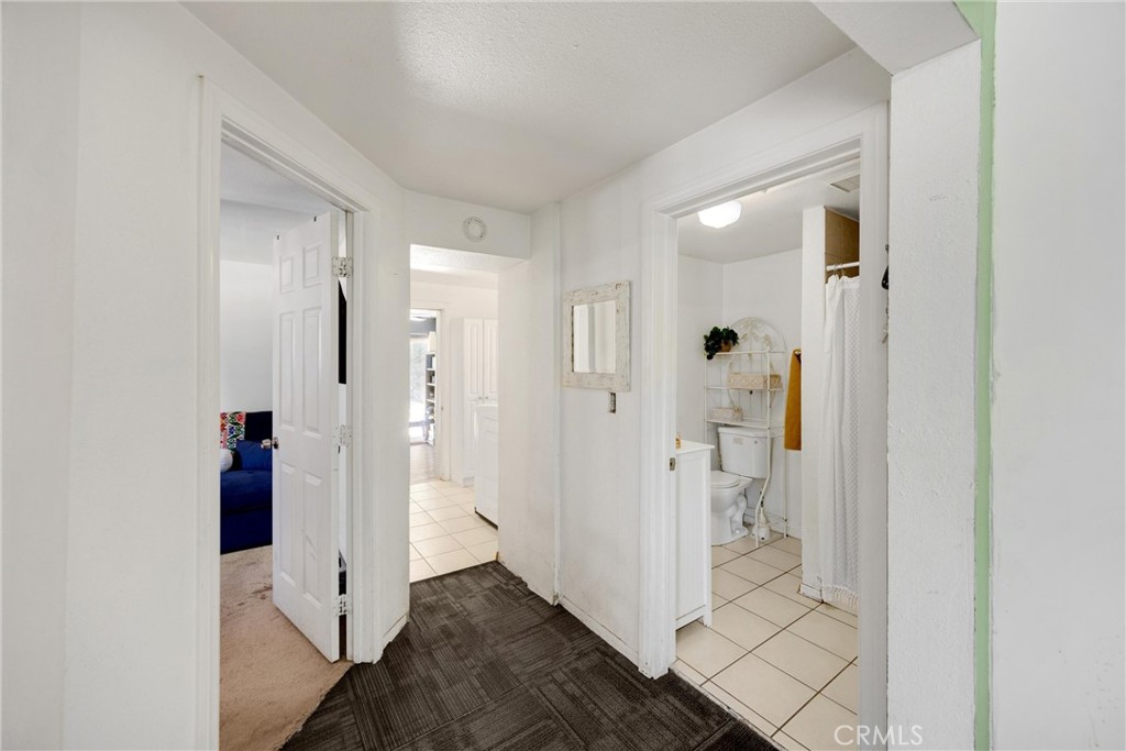 1003 West Stevenson Street Colton, CA 92324 - Photo 10 of 27 wooden floor with a bathroom and a glass door
