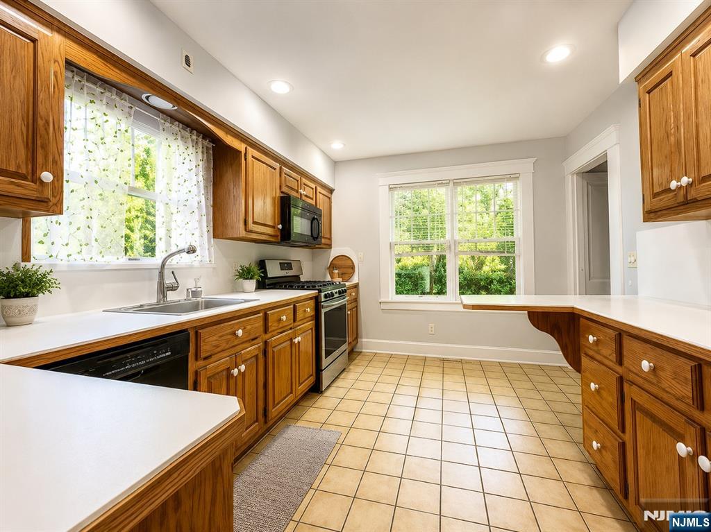 84 Valley View Avenue Ridgewood, NJ 07450 - Photo 6 of 20 a kitchen with a sink a window and cabinets