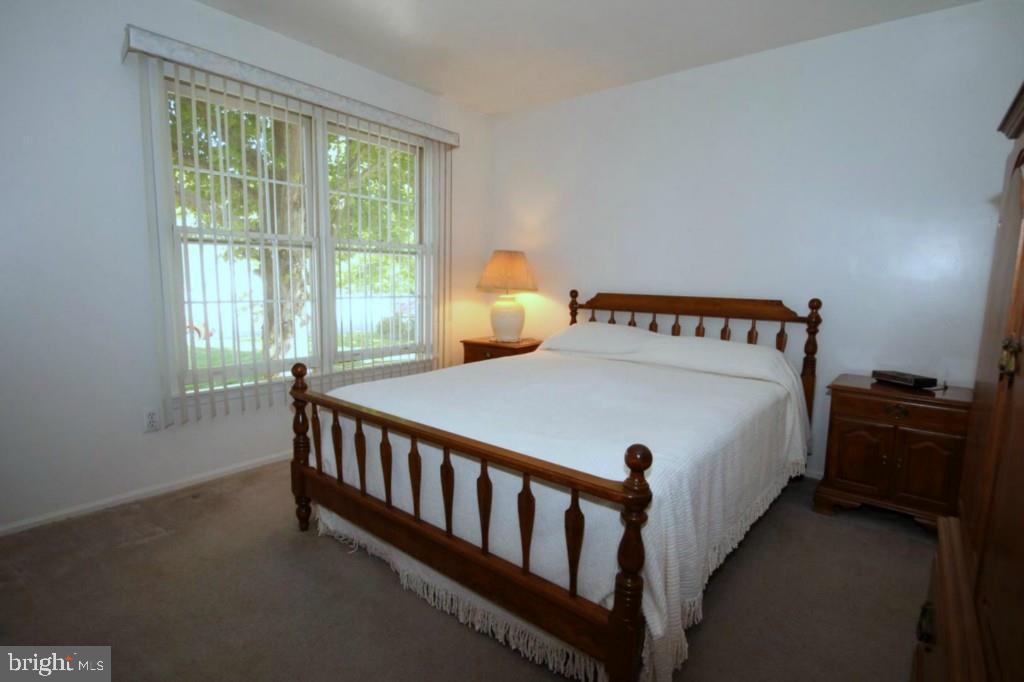 228 Schooner Road Manahawkin, NJ 08050 - Photo 11 of 19 a bed sitting in a bedroom next to a window