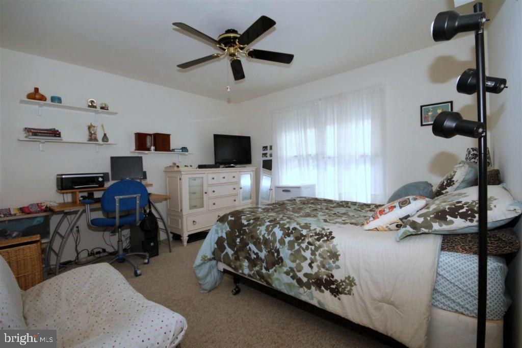 228 Schooner Road Manahawkin, NJ 08050 - Photo 13 of 19 a bedroom with bed a window and a flat screen tv