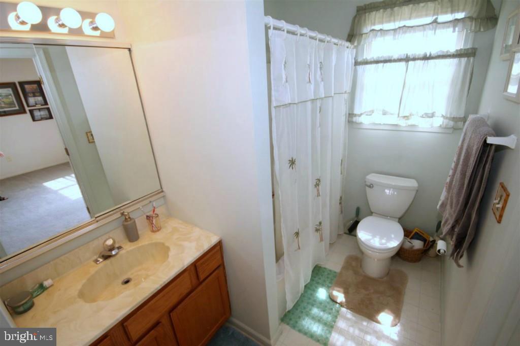 228 Schooner Road Manahawkin, NJ 08050 - Photo 14 of 19 a bathroom with a toilet sink and mirror