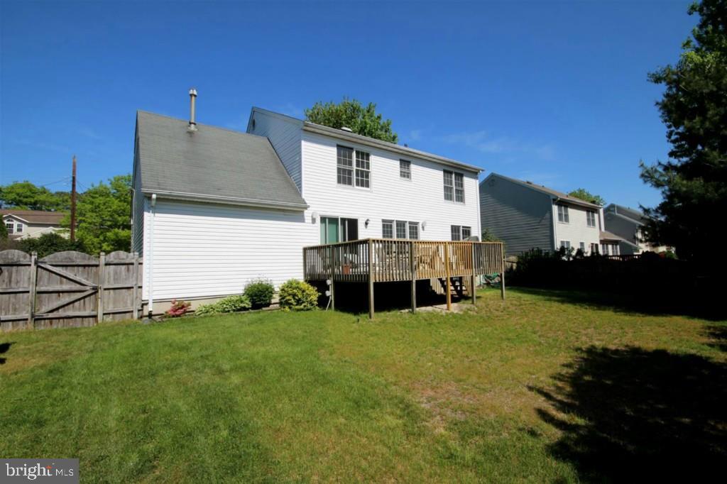 228 Schooner Road Manahawkin, NJ 08050 - Photo 18 of 19 a view of a house with a big yard and large trees