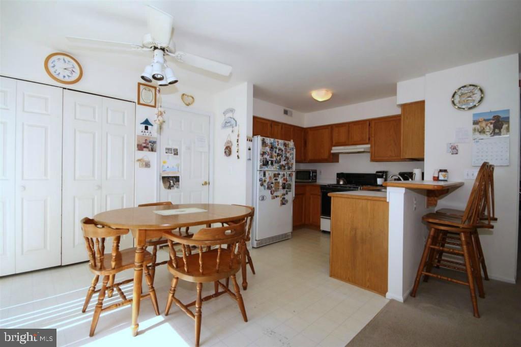 228 Schooner Road Manahawkin, NJ 08050 - Photo 6 of 19 a view of a dining room with furniture and a chandelier